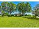 Exterior shot of clubhouse with a well-maintained lawn and flag poles at 36700 Oconee Ave, Eustis, FL 32736
