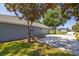 Gray home with a two car garage and long driveway lined with grass at 36700 Oconee Ave, Eustis, FL 32736