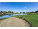 Scenic golf course view featuring a water hazard and sand bunker at 36700 Oconee Ave, Eustis, FL 32736