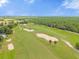 Scenic aerial view of a golf course with lush fairways, strategically placed sand traps, and mature trees at 36700 Oconee Ave, Eustis, FL 32736