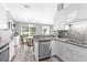 Modern kitchen with stainless steel appliances, granite countertops, and white cabinetry at 36700 Oconee Ave, Eustis, FL 32736