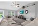 Cozy living room with a large sectional sofa, entertainment center, and ample natural light at 36700 Oconee Ave, Eustis, FL 32736