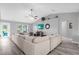 Bright living room featuring vaulted ceilings, a ceiling fan, and a large sectional sofa at 36700 Oconee Ave, Eustis, FL 32736