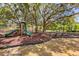 Large playground with multiple slides and play structures, set in a shaded area with lush landscaping at 36700 Oconee Ave, Eustis, FL 32736