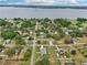 Aerial shot of neighborhood homes near a scenic lake or large body of water covered with dense forests at 395 S Dixie Dr, Howey In The Hills, FL 34737