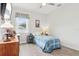 Bedroom with wood floors, a blue plaid bedspread, and a ceiling fan at 395 S Dixie Dr, Howey In The Hills, FL 34737