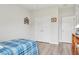 Bedroom with wood floors, double closets, and white walls at 395 S Dixie Dr, Howey In The Hills, FL 34737