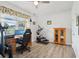 Bedroom featuring an elliptical machine, desk, hardwood floors, and a ceiling fan at 395 S Dixie Dr, Howey In The Hills, FL 34737