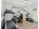 Bedroom featuring a treadmill, elliptical machine, desk, and ceiling fan at 395 S Dixie Dr, Howey In The Hills, FL 34737
