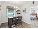 Bright dining area with a breakfast bar, pendant lighting, and views of the backyard through a window at 395 S Dixie Dr, Howey In The Hills, FL 34737