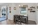 Bright dining area with a breakfast bar, pendant lighting, and views of the backyard through a sliding glass door at 395 S Dixie Dr, Howey In The Hills, FL 34737