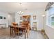 Inviting dining room featuring wood flooring, a chandelier, and traditional furnishings, ideal for Gathering meals at 395 S Dixie Dr, Howey In The Hills, FL 34737