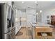 Well-equipped kitchen with a stainless steel fridge, center island, light countertops, and modern cabinets at 395 S Dixie Dr, Howey In The Hills, FL 34737