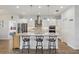 Open kitchen featuring a central island with bar seating, stainless steel appliances, and white cabinets at 395 S Dixie Dr, Howey In The Hills, FL 34737