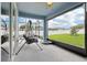 Screened lanai with a swing and seating area overlooking the backyard at 395 S Dixie Dr, Howey In The Hills, FL 34737