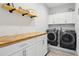 Laundry room featuring a wooden countertop, cabinets, and washer and dryer units at 395 S Dixie Dr, Howey In The Hills, FL 34737