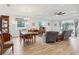 Bright living and dining area with wood floors, recessed lighting, and modern furnishings at 395 S Dixie Dr, Howey In The Hills, FL 34737