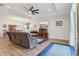 Spacious living area with hardwood floors, a modern ceiling fan, and plenty of natural light at 395 S Dixie Dr, Howey In The Hills, FL 34737