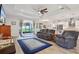 Open-concept living area with hardwood floors, recessed lighting, and access to the backyard at 395 S Dixie Dr, Howey In The Hills, FL 34737