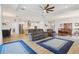 Open-concept living space with modern lighting, a gray sofa set, and stainless steel appliances at 395 S Dixie Dr, Howey In The Hills, FL 34737