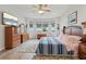 Main bedroom featuring a dresser, ceiling fan, and natural light at 395 S Dixie Dr, Howey In The Hills, FL 34737