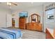 Main bedroom featuring wood floors, a dresser, and a ceiling fan at 395 S Dixie Dr, Howey In The Hills, FL 34737