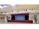 Auditorium space with a stage, lighting, and simple decor, offering a versatile venue at 4087 Capland Ave, Clermont, FL 34711