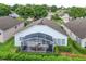 Aerial view of backyard with a screened-in lanai and well-maintained landscaping providing privacy at 4087 Capland Ave, Clermont, FL 34711