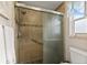 Bathroom with a glass-enclosed shower, tiled walls, and ample natural light at 4087 Capland Ave, Clermont, FL 34711