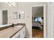 Bathroom with granite counters and a view to the main bedroom with access to the lanai at 4087 Capland Ave, Clermont, FL 34711