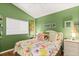 Bright bedroom featuring a window, cheerful wall color, and decorative decor at 4087 Capland Ave, Clermont, FL 34711