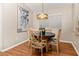 Comfortable dining area with natural light, hardwood floors, and stylish chandelier at 4087 Capland Ave, Clermont, FL 34711