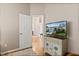 Inviting hallway with hardwood floors leading to a living room and a television set at 4087 Capland Ave, Clermont, FL 34711