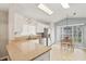 Bright kitchen featuring granite countertops, stainless steel appliances, tile floors, and natural light at 4087 Capland Ave, Clermont, FL 34711