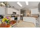 Bright kitchen featuring white cabinets, stainless steel appliances, and tiled countertops at 4087 Capland Ave, Clermont, FL 34711