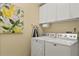 Well-equipped laundry room with a Maytag washer and dryer and ample cabinet space at 4087 Capland Ave, Clermont, FL 34711