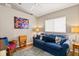 Comfortable living area featuring a plush blue sofa, colorful pillows, and a cozy atmosphere at 4087 Capland Ave, Clermont, FL 34711