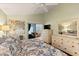 Bright main bedroom with ceiling fan, ensuite bath, and slider to a relaxing screened-in lanai at 4087 Capland Ave, Clermont, FL 34711