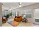 Bright sitting area with a desk, comfortable seating, and plenty of natural light from many windows at 4087 Capland Ave, Clermont, FL 34711