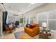 Bright sitting area with a desk, comfortable seating, and plenty of natural light from many windows at 4087 Capland Ave, Clermont, FL 34711