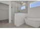 Bright bathroom featuring a glass enclosed shower and a modern freestanding tub with a window at 5036 Blanket Flower St, Apopka, FL 32712