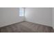 Carpeted bedroom featuring a window bringing in natural light, and neutral walls at 5036 Blanket Flower St, Apopka, FL 32712