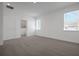 Spacious bedroom with carpet, natural light from two windows, and an en-suite bathroom at 5036 Blanket Flower St, Apopka, FL 32712