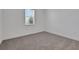 Bright, carpeted bedroom with a large window providing natural light at 5036 Blanket Flower St, Apopka, FL 32712