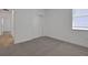 Neutral bedroom featuring a window, carpet flooring, and a closet with sliding doors at 5036 Blanket Flower St, Apopka, FL 32712