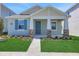 Charming single-story home showcasing manicured lawn and stone-accented porch columns at 5036 Blanket Flower St, Apopka, FL 32712