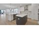 Eat-in kitchen with gray island and white cabinets, lots of counter space, and stainless steel appliances at 5036 Blanket Flower St, Apopka, FL 32712