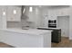 Well-equipped kitchen with stainless steel appliances, white cabinetry, and a breakfast bar at 5036 Blanket Flower St, Apopka, FL 32712