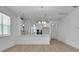 Bright, open kitchen with a modern chandelier and stainless steel appliances at 5036 Blanket Flower St, Apopka, FL 32712