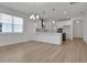 Open-concept living space with hardwood floors and modern lighting fixtures at 5036 Blanket Flower St, Apopka, FL 32712